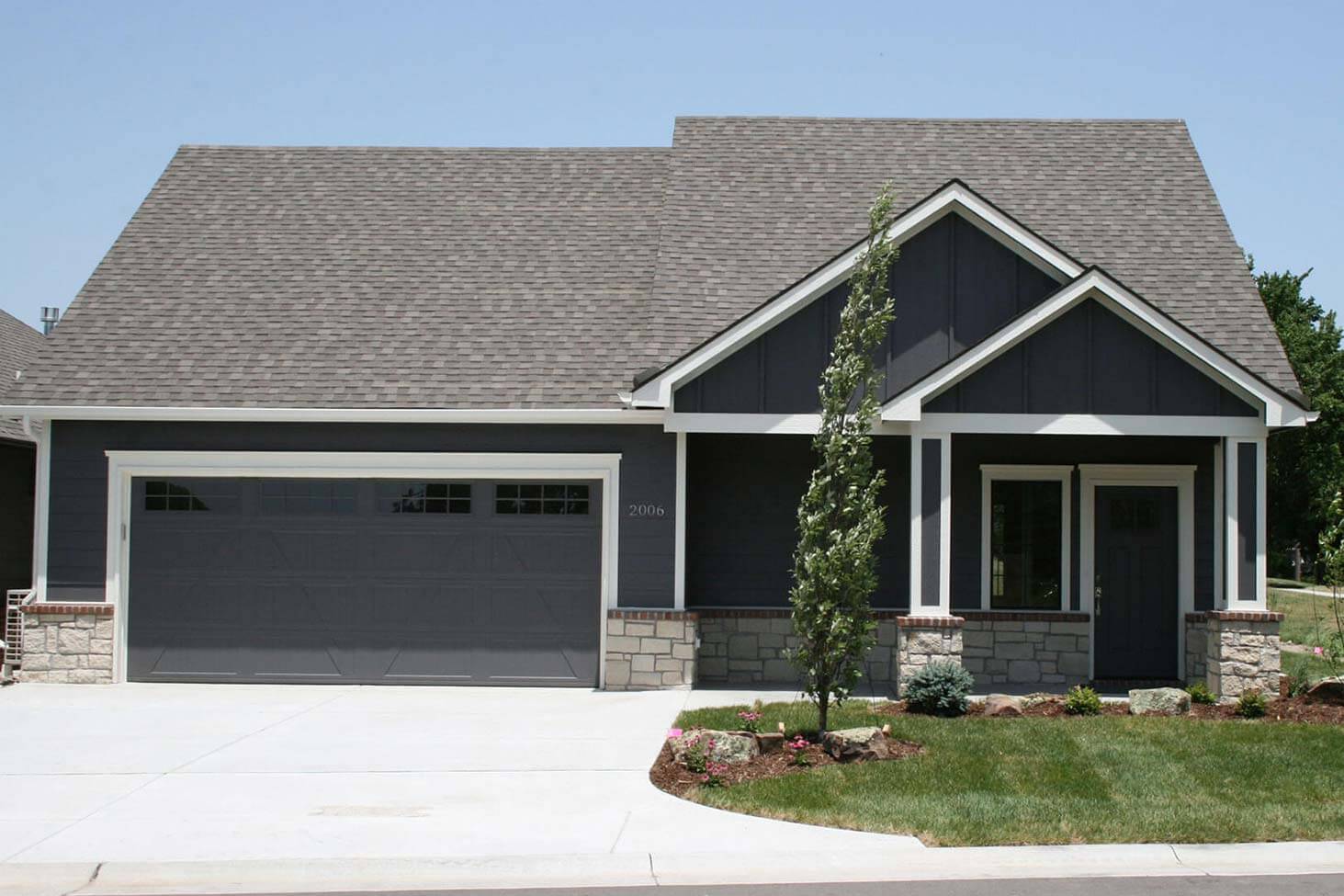 The Porter plan model home. Front view of home with dark blue exterior.