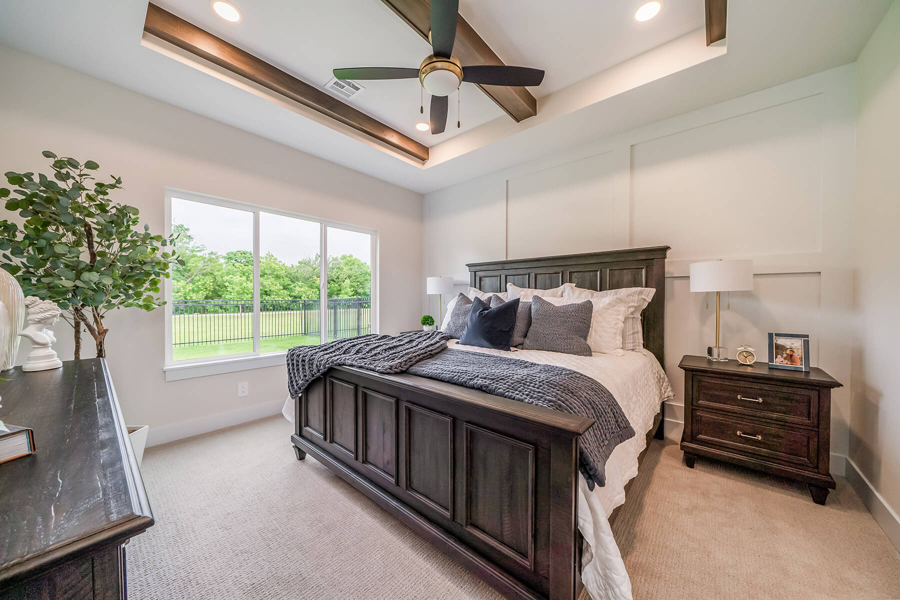 Bedroom with accent wall and large windows covering one wall.