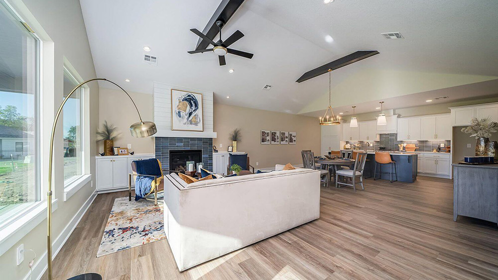 A beautifully decorated open concept living room / kitchen.
